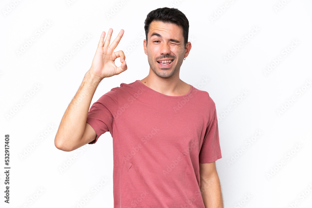 Young handsome man over isolated white background showing ok sign with fingers Young handsome man over isolated white background showing ok sign with fingers