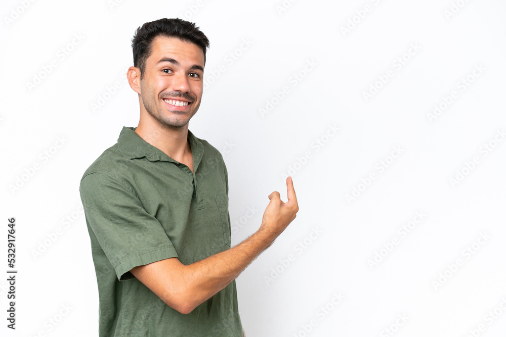 Young handsome man over isolated white background pointing back Young handsome man over isolated white background pointing back