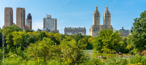 Skyline panorama with Eldorado building and reservoir with boats in Central Park in midtown Manhattan in New York City