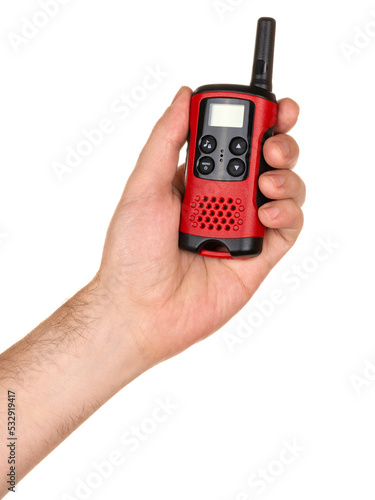 Wallpaper Mural Man's hand holding handheld radio communication device walkie-talkie with display in red color. Isolated on white background. Torontodigital.ca