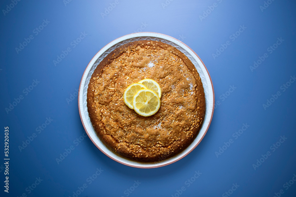 Lemon cake seen from above decorated with a few slices of fruit. Lemon cake seen from above decorated with a few slices of fruit.
