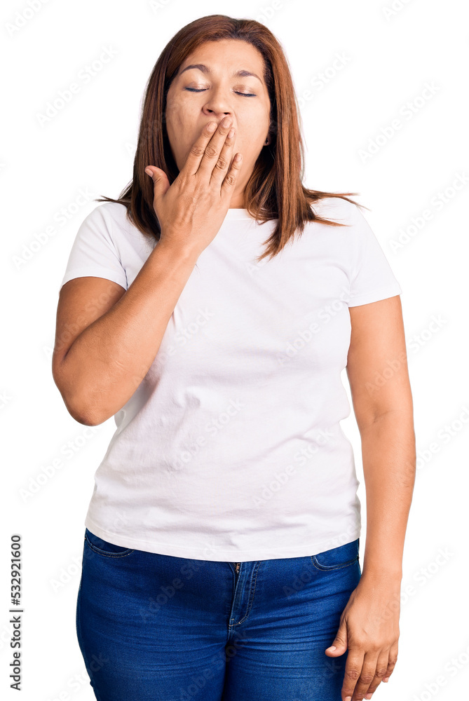 Middle age latin woman wearing casual white tshirt bored yawning tired covering mouth with hand. restless and sleepiness. Middle age latin woman wearing casual white tshirt bored yawning tired covering mouth with hand. restless and sleepiness.