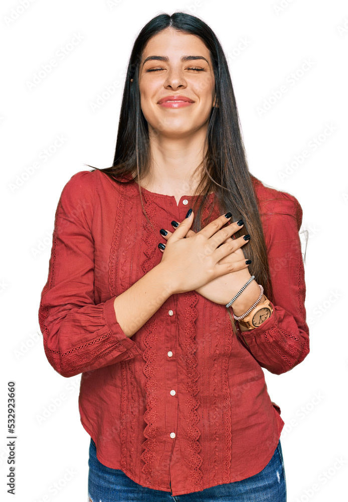 Young hispanic woman wearing casual clothes smiling with hands on chest with closed eyes and grateful gesture on face. health concept. Young hispanic woman wearing casual clothes smiling with hands on chest with closed eyes and grateful gesture on face. health concept.