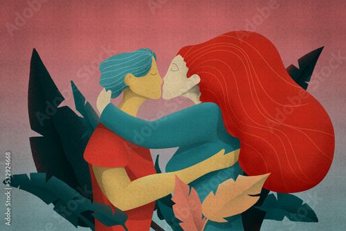 Kiss of love between a woman with red hair and a man in the middle of the leaves of nature