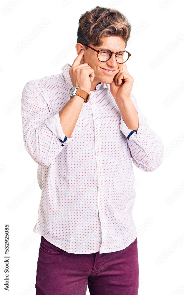 Young handsome man wearing business clothes and glasses covering ears with fingers with annoyed expression for the noise of loud music. deaf concept. Young handsome man wearing business clothes and glasses covering ears with fingers with annoyed expression for the noise of loud music. deaf concept.