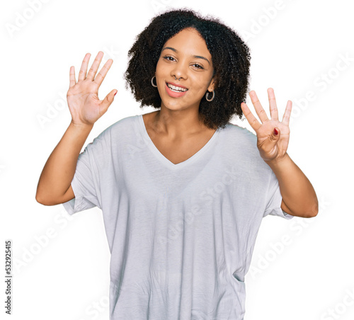 Young african american girl wearing casual clothes showing and pointing up with fingers number nine while smiling confident and happy.