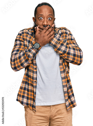 Young african american man wearing casual clothes shocked covering mouth with hands for mistake. secret concept.