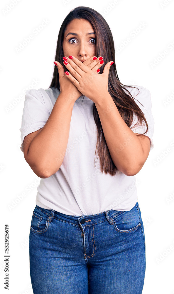 Young beautiful brunette woman wearing casual t-shirt shocked covering mouth with hands for mistake. secret concept. Young beautiful brunette woman wearing casual t-shirt shocked covering mouth with hands for mistake. secret concept.