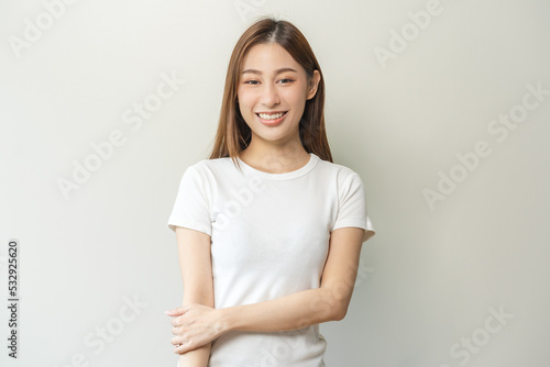 Smile positive, attractive asian young woman wearing casual, portrait of beautiful brunette her with long hair, feeling happy looking at camera, standing cross arms chest isolated on white background.