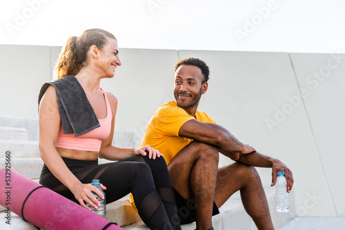 Multiethnic sportive couple training outdoor - Multiracial atlethes doing functional training outside, healthy lifestyle, sport and fitness concepts