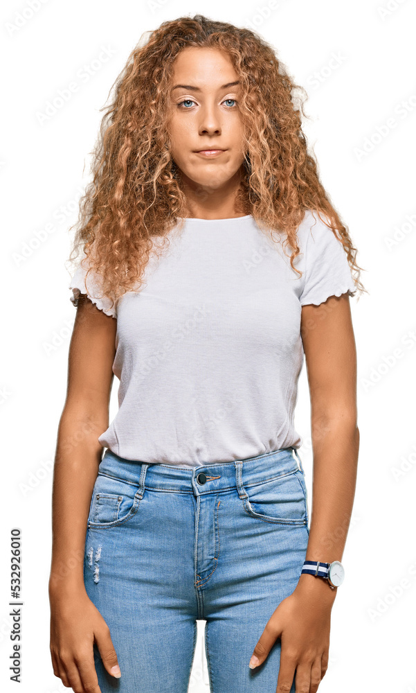 Fototapeta premium Beautiful caucasian teenager girl wearing casual white tshirt relaxed with serious expression on face. simple and natural looking at the camera.