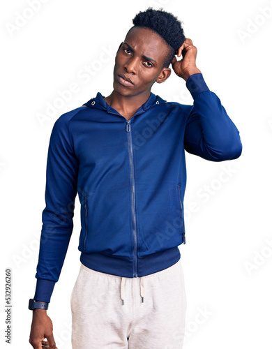 Fotografie Young african american man wearing sportswear confuse and wondering about question