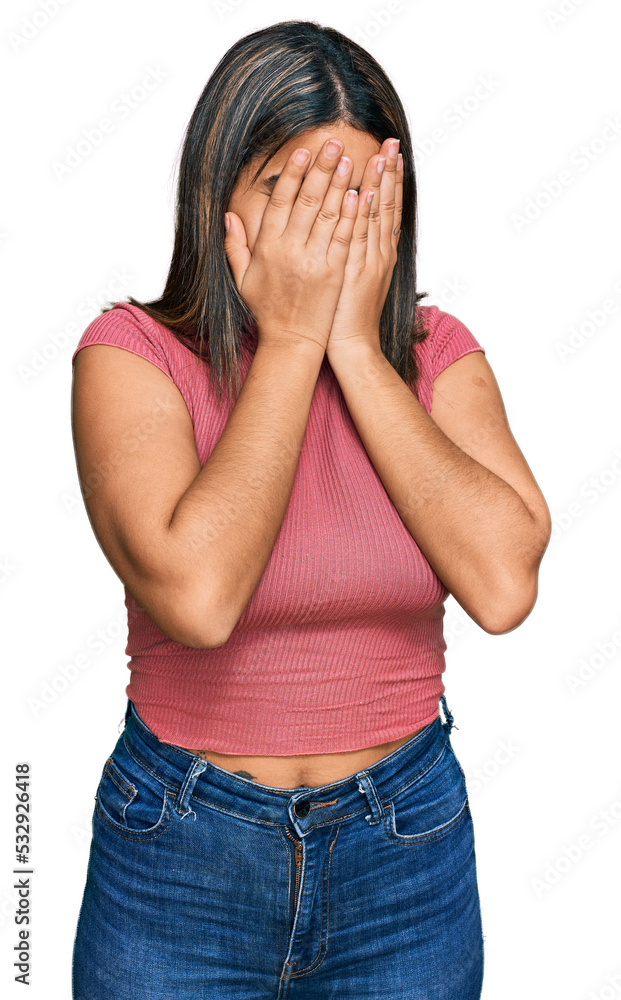 Young hispanic girl wearing casual t shirt with sad expression covering face with hands while crying. depression concept. Young hispanic girl wearing casual t shirt with sad expression covering face with hands while crying. depression concept.