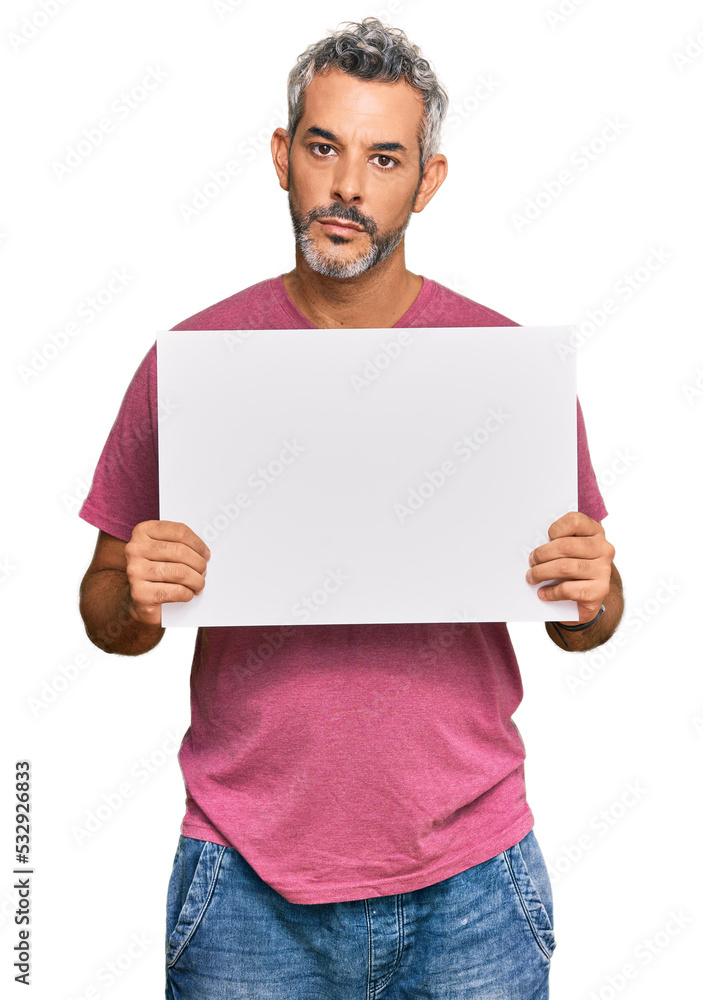Middle age grey-haired man holding blank empty banner thinking attitude and sober expression looking self confident Middle age grey-haired man holding blank empty banner thinking attitude and sober expression looking self confident