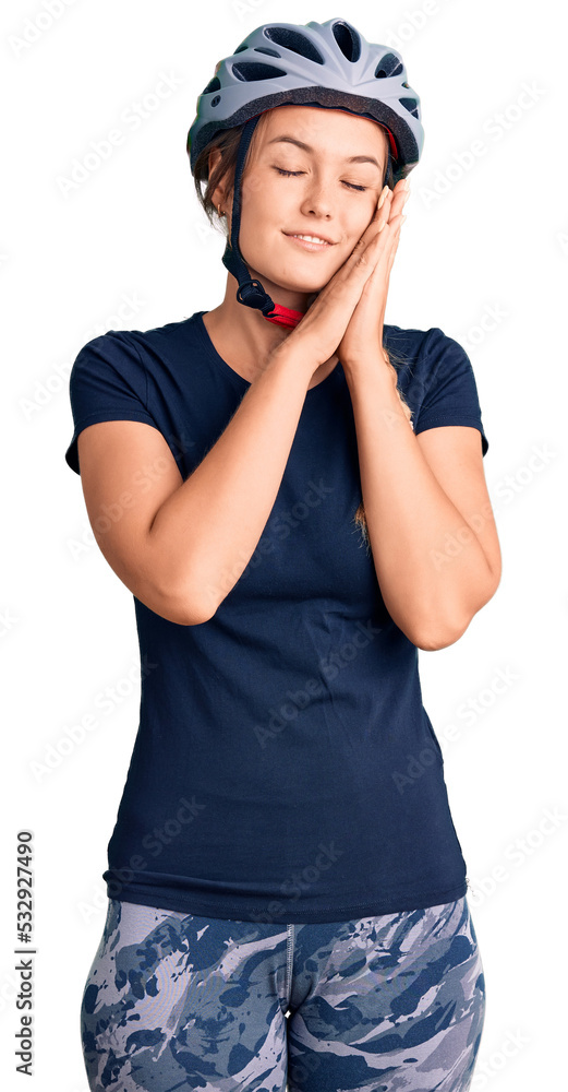 Beautiful caucasian woman wearing bike helmet sleeping tired dreaming and posing with hands together while smiling with closed eyes. Beautiful caucasian woman wearing bike helmet sleeping tired dreaming and posing with hands together while smiling with closed eyes.