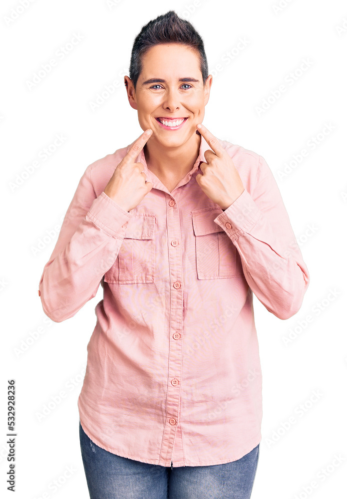 Young woman with short hair wearing casual clothes smiling with open mouth, fingers pointing and forcing cheerful smile Young woman with short hair wearing casual clothes smiling with open mouth, fingers pointing and forcing cheerful smile