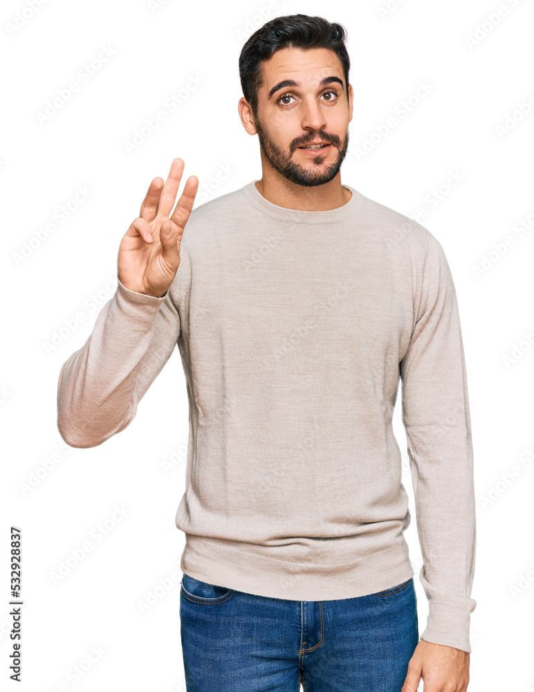 Young hispanic man wearing casual clothes showing and pointing up with fingers number three while smiling confident and happy. Young hispanic man wearing casual clothes showing and pointing up with fingers number three while smiling confident and happy.