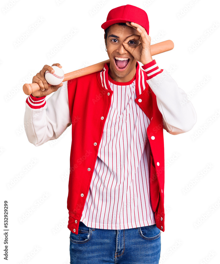 Young african amercian man playing baseball holding bat and ball smiling happy doing ok sign with hand on eye looking through fingers Young african amercian man playing baseball holding bat and ball smiling happy doing ok sign with hand on eye looking through fingers