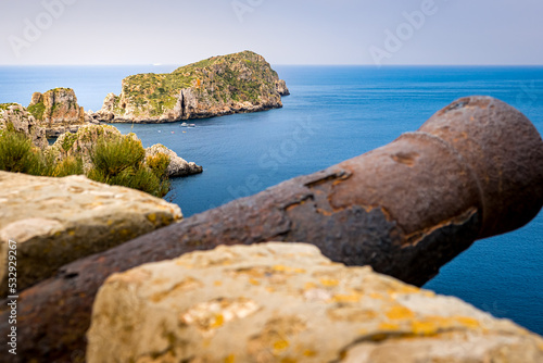 Panoramic view from viewpoint of the Malgrat Islands cannon in Santa Ponsa above the mediterranean sea with islands Illes Malgrats in the background and a blurred old rusty cannon in the foreground. photo