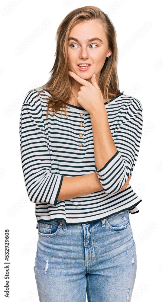 Beautiful blonde woman wearing casual clothes with hand on chin thinking about question, pensive expression. smiling with thoughtful face. doubt concept. Beautiful blonde woman wearing casual clothes with hand on chin thinking about question, pensive expression. smiling with thoughtful face. doubt concept.