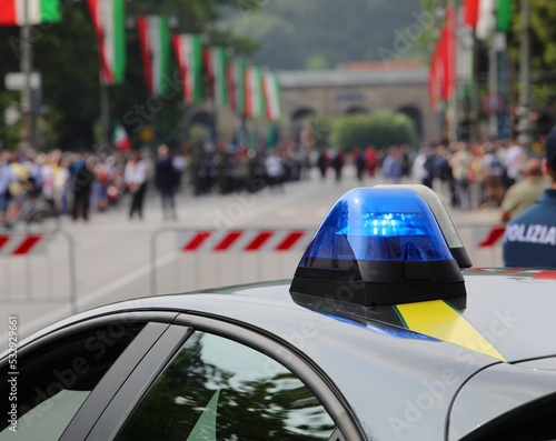 Police car siren during outdoor demonstration and flags