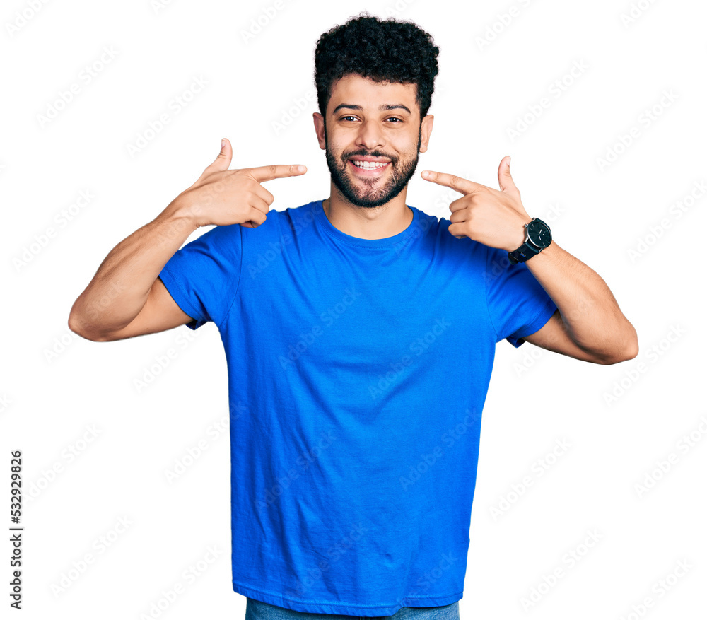 Young arab man with beard wearing casual blue t shirt smiling cheerful showing and pointing with fingers teeth and mouth. dental health concept. Young arab man with beard wearing casual blue t shirt smiling cheerful showing and pointing with fingers teeth and mouth. dental health concept.