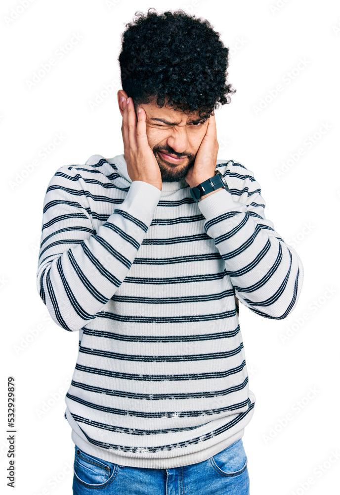 Young arab man with beard wearing casual striped sweater covering ears with fingers with annoyed expression for the noise of loud music. deaf concept. Young arab man with beard wearing casual striped sweater covering ears with fingers with annoyed expression for the noise of loud music. deaf concept.