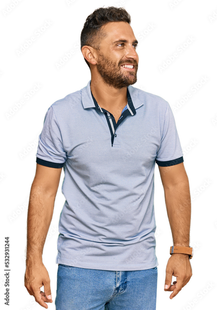Handsome man with beard wearing casual clothes looking away to side with smile on face, natural expression. laughing confident. Handsome man with beard wearing casual clothes looking away to side with smile on face, natural expression. laughing confident.