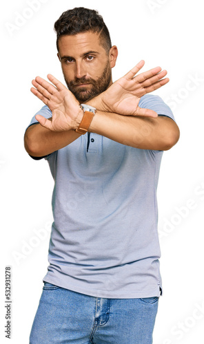 Handsome man with beard wearing casual clothes rejection expression crossing arms and palms doing negative sign, angry face