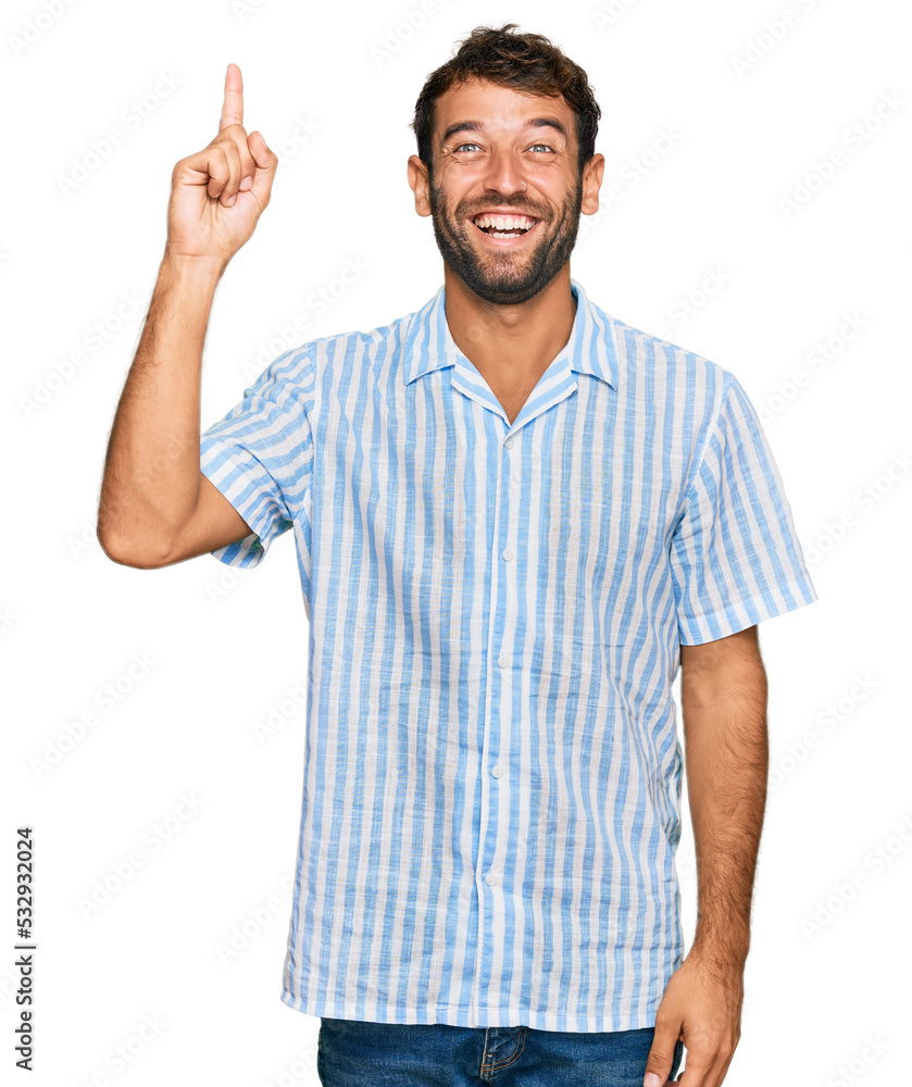 Handsome young man with beard wearing casual fresh shirt pointing finger up with successful idea. exited and happy. number one. Handsome young man with beard wearing casual fresh shirt pointing finger up with successful idea. exited and happy. number one.