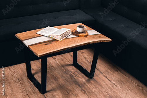 Epoxy wooden table. A cup of coffee and a book on the table. Morning and breakfast © amdre100