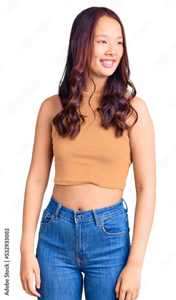 Young beautiful chinese girl wearing casual clothes looking away to side with smile on face, natural expression. laughing confident. Young beautiful chinese girl wearing casual clothes looking away to side with smile on face, natural expression. laughing confident.