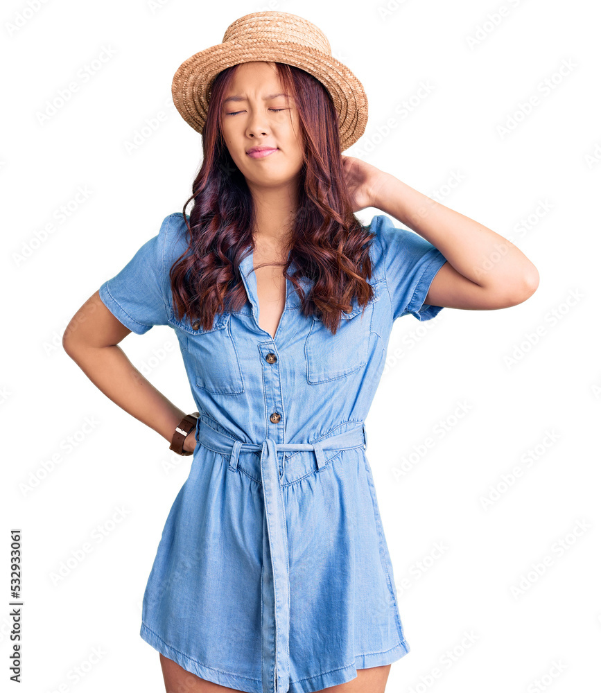 Young beautiful chinese girl wearing summer hat suffering of neck ache injury, touching neck with hand, muscular pain Young beautiful chinese girl wearing summer hat suffering of neck ache injury, touching neck with hand, muscular pain