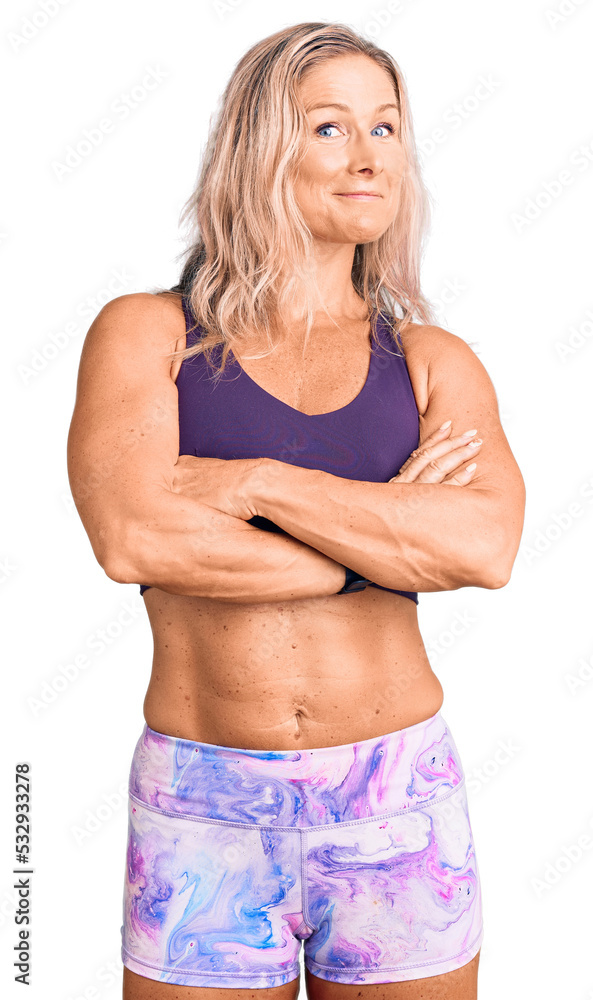 Φωτογραφία Middle age fit blonde woman wearing sportswear happy face smiling with crossed arms looking at the camera