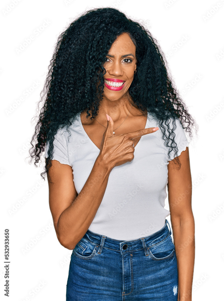 Middle age african american woman wearing casual white t shirt cheerful with a smile of face pointing with hand and finger up to the side with happy and natural expression on face Middle age african american woman wearing casual white t shirt cheerful with a smile of face pointing with hand and finger up to the side with happy and natural expression on face