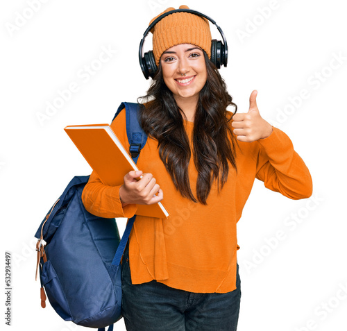 Fotografía Beautiful brunette young woman wearing student backpack and holding books smilin