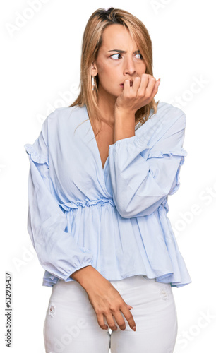 Beautiful blonde business woman wearing casual clothes looking stressed and nervous with hands on mouth biting nails. anxiety problem.