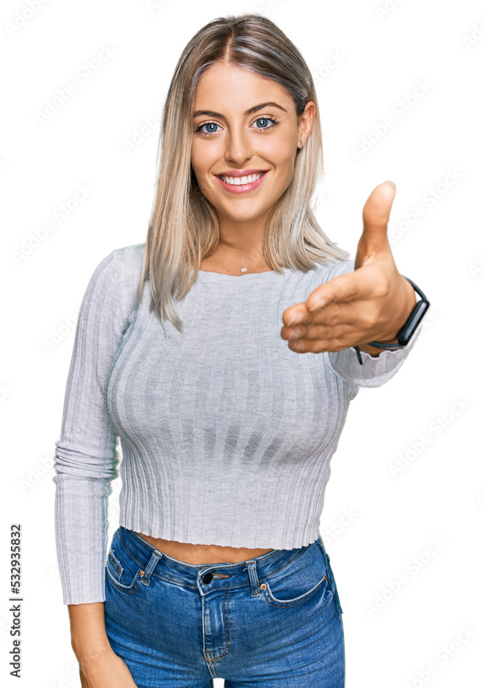 Beautiful blonde woman wearing casual clothes smiling friendly offering handshake as greeting and welcoming. successful business. Beautiful blonde woman wearing casual clothes smiling friendly offering handshake as greeting and welcoming. successful business.