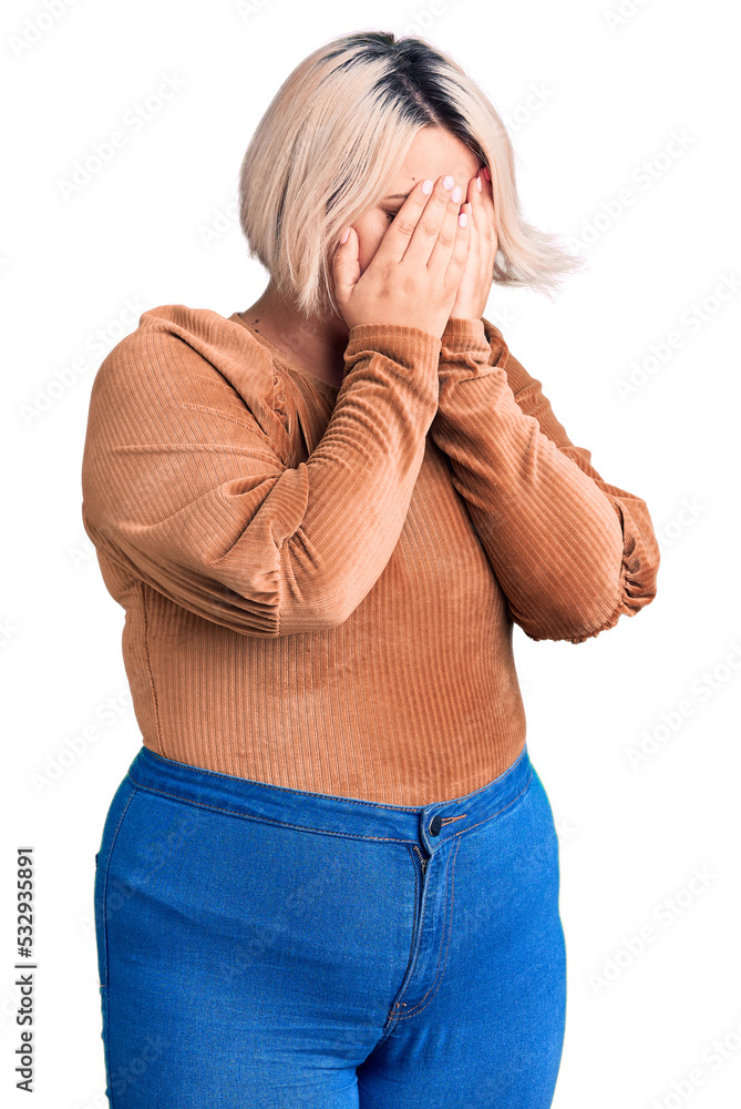 Young blonde plus size woman wearing casual sweater with sad expression covering face with hands while crying. depression concept. Young blonde plus size woman wearing casual sweater with sad expression covering face with hands while crying. depression concept.