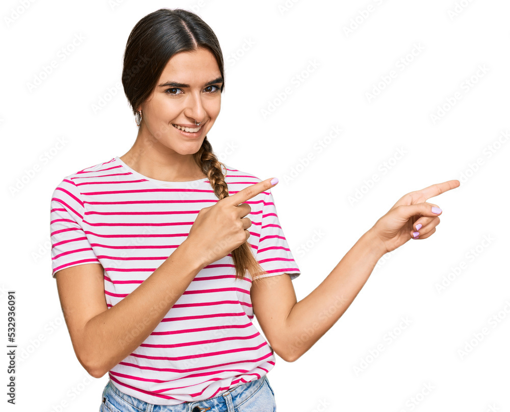Young hispanic woman wearing casual clothes smiling and looking at the camera pointing with two hands and fingers to the side. Young hispanic woman wearing casual clothes smiling and looking at the camera pointing with two hands and fingers to the side.
