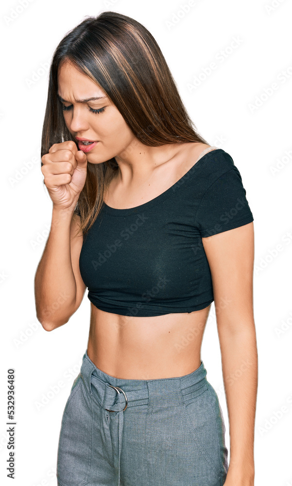 Young brunette woman wearing casual clothes feeling unwell and coughing as symptom for cold or bronchitis. health care concept. Young brunette woman wearing casual clothes feeling unwell and coughing as symptom for cold or bronchitis. health care concept.