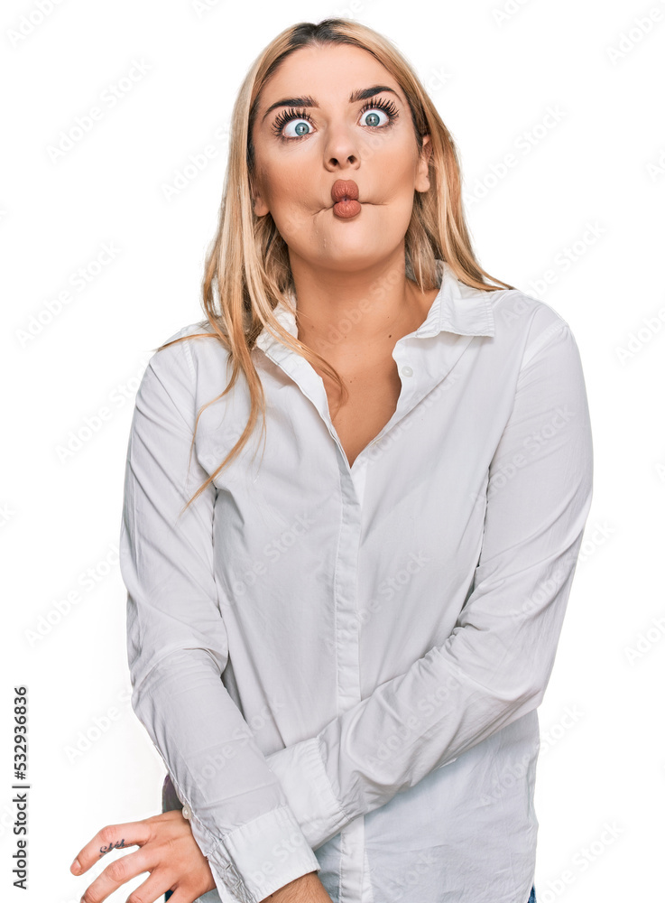 Young caucasian woman wearing casual clothes making fish face with lips, crazy and comical gesture. funny expression. Young caucasian woman wearing casual clothes making fish face with lips, crazy and comical gesture. funny expression.