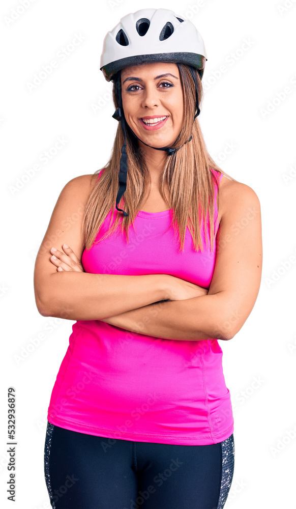 Young beautiful woman wearing bike helmet happy face smiling with crossed arms looking at the camera. positive person. Young beautiful woman wearing bike helmet happy face smiling with crossed arms looking at the camera. positive person.