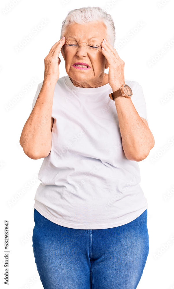 Senior beautiful woman with blue eyes and grey hair wearing casual white tshirt with hand on head, headache because stress. suffering migraine. Senior beautiful woman with blue eyes and grey hair wearing casual white tshirt with hand on head, headache because stress. suffering migraine.