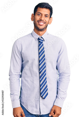 Young latin man wearing business clothes looking positive and happy standing and smiling with a confident smile showing teeth