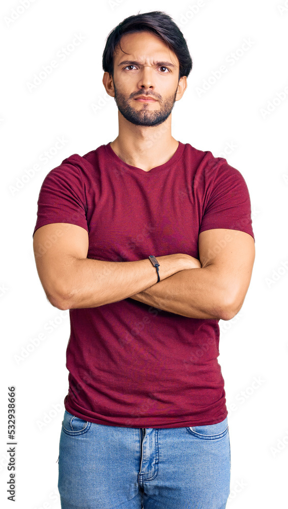 Handsome hispanic man wearing casual clothes skeptic and nervous, disapproving expression on face with crossed arms. negative person. Handsome hispanic man wearing casual clothes skeptic and nervous, disapproving expression on face with crossed arms. negative person.