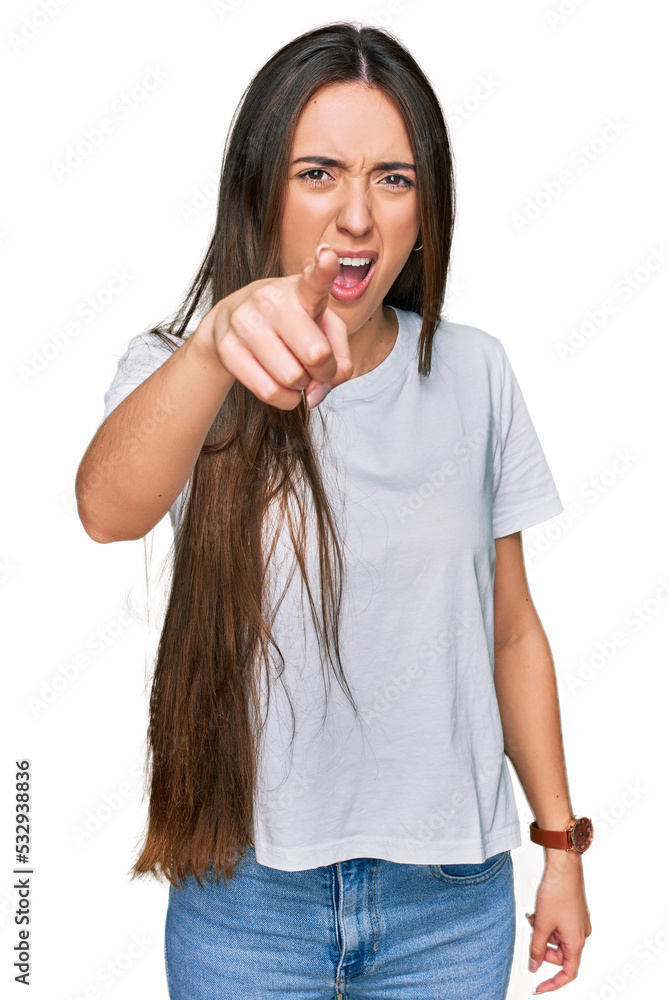 Young hispanic girl wearing casual white t shirt pointing displeased and frustrated to the camera, angry and furious with you Young hispanic girl wearing casual white t shirt pointing displeased and frustrated to the camera, angry and furious with you