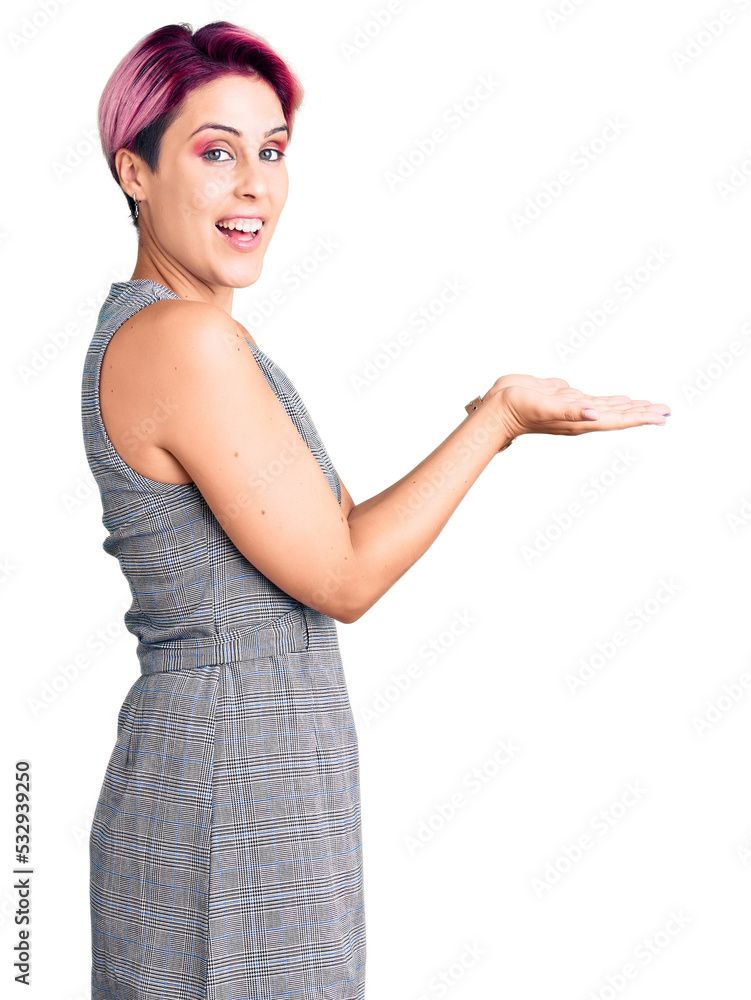 Young beautiful woman with pink hair wearing casual clothes pointing aside with hands open palms showing copy space, presenting advertisement smiling excited happy Young beautiful woman with pink hair wearing casual clothes pointing aside with hands open palms showing copy space, presenting advertisement smiling excited happy