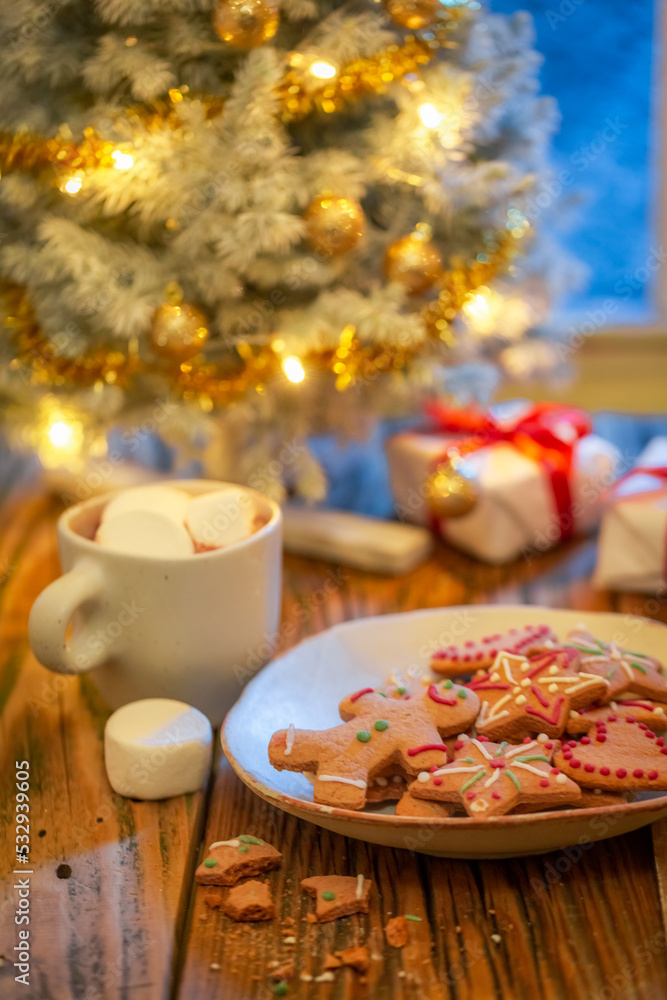 Gingerbread cookies and presents under Christmas tree. Background for Christmas.