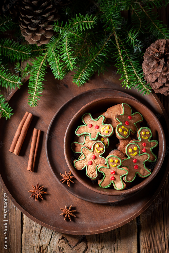 Homemade cookies in the shape of man on wooden plate